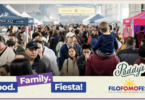 Crowded outdoor festival scene with diverse attendees, vendor tents, and banners for Food. Family. Fiesta! and Paddy's branding amid the crowd.