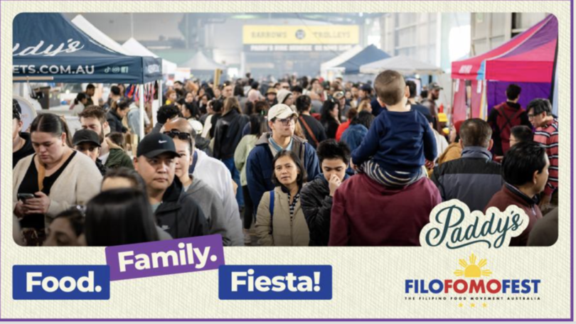Crowded outdoor festival scene with diverse attendees, vendor tents, and banners for Food. Family. Fiesta! and Paddy's branding amid the crowd.