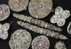 Assorted circular metal discs with intricate Celtic knotwork on a black background.