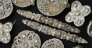 Assorted circular metal discs with intricate Celtic knotwork on a black background.