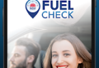 NSW Government FuelCheck app splash screen on phone, showing a smiling woman in a car.